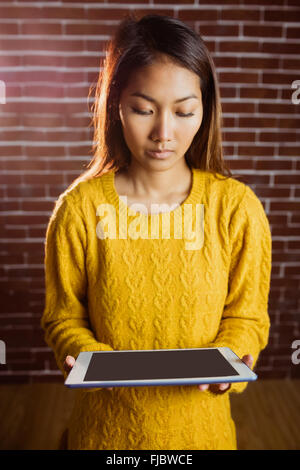 Focused asian woman using tablet Stock Photo