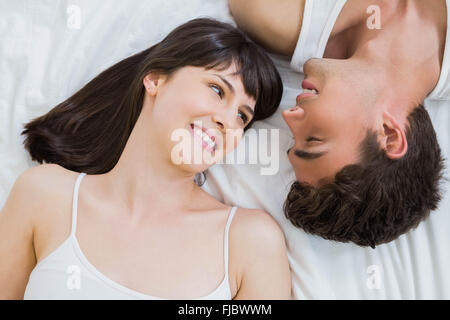young couple lying on bed Stock Photo
