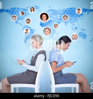 Composite image of businesswomen sitting back-to-back on the chairs Stock Photo