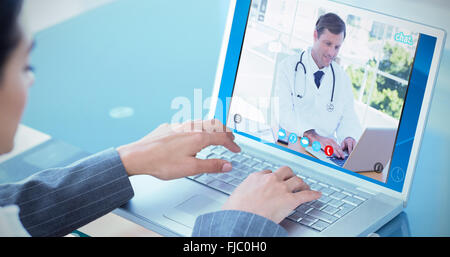 Composite image of businesswoman using laptop Stock Photo