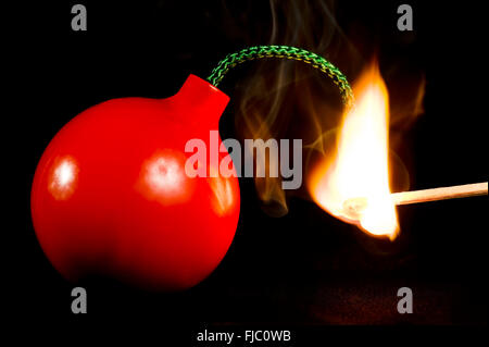 A Bomb Being Lit With a Match. Stock Photo