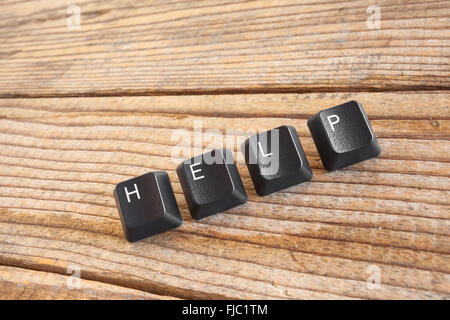 "HELP" wrote with keyboard keys on wooden background Stock Photo