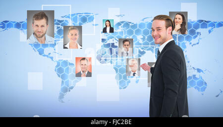 Composite image of smiling businessman gesturing and looking at camera Stock Photo