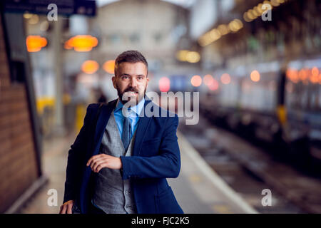 Hipster businessman at the staition running, catching the train Stock Photo