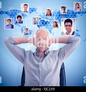 Composite image of relaxed mature businessman with hands behind head Stock Photo