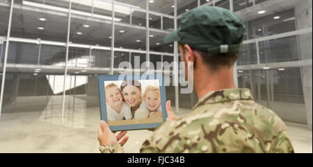 Composite image of soldier using tablet pc Stock Photo