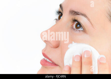 Young beautiful woman cleaning skin with cotton pad Stock Photo