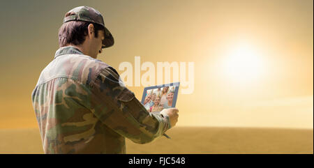 Composite image of army officer using tablet Stock Photo