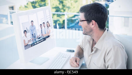 Composite image of casual businessman using computer Stock Photo