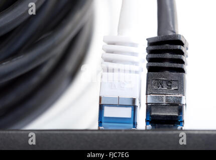 Network cables connected to a switch Stock Photo