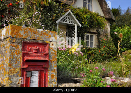 Victorian Post box in the wall of a thatched cottage near Lacock, Wiltshire UK Stock Photo