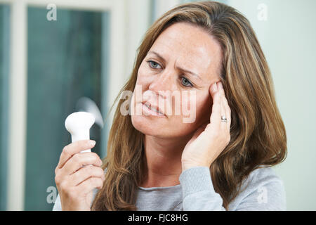 Mature Woman Experiencing Hot Flush From Menopause Stock Photo