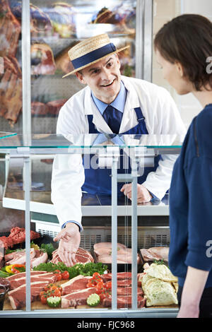 Butcher Serving Customer In Shop Stock Photo - Alamy