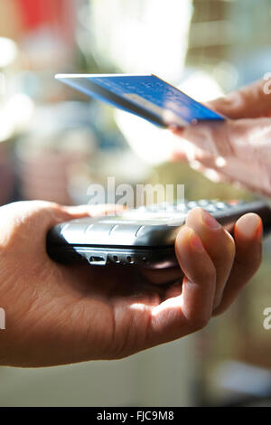 Customer Making Purchase Using Contactless Payment Stock Photo