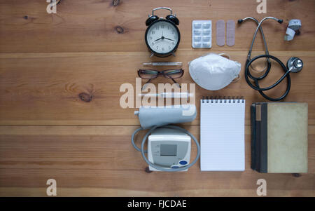 Medical objects laid out on a wooden table with space Stock Photo