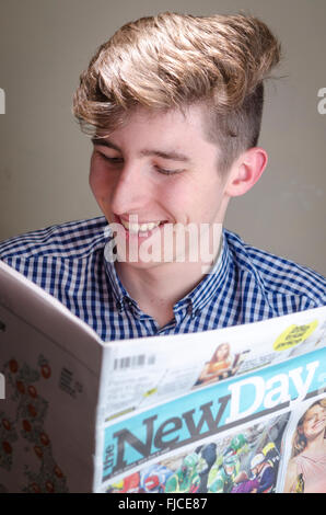 Young Man Reading New Day Newspaper Stock Photo