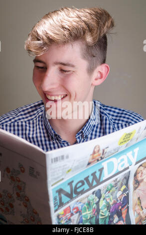 Young Man Reading New Day Newspaper Stock Photo