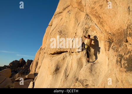 Woman Rock Climbing at Hidden Valley, Joshua Tree National Park California USA Stock Photo