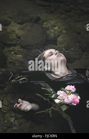 Beautiful drown woman in a river . Ophelia concept Stock Photo