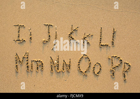 Alphabet written in light beach sand, part 2 of 4 (I-P) Stock Photo
