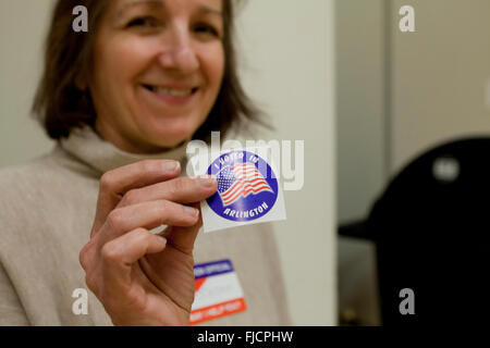 Arlington, Virginia, USA. 1st March, 2016. Virginians cast their votes in a pooling place for the US presidential primary in Arlington, on this Super Tuesday. Pictured: Woman holding 'I Voted' sticker. Credit:  B Christopher/Alamy Live News Stock Photo