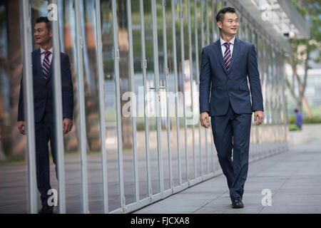 Portrait of a Chinese businessman outside modern office building. Stock Photo