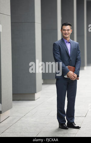 A happy looking Asian businessman Stock Photo - Alamy