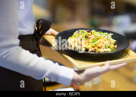 Chinese waitress serving in restaurant Stock Photo