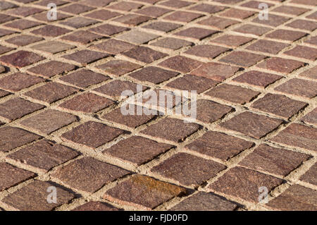 Decorative square tiled ground in sunlight, shallow depth of field Stock Photo