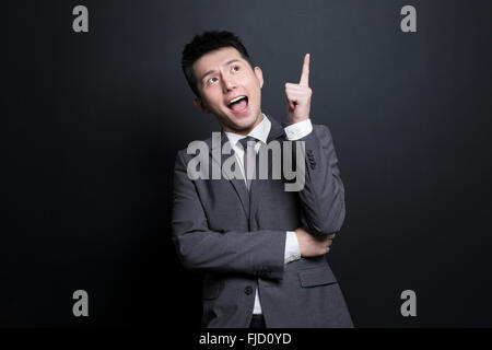 Excited Chinese businessman having a good idea Stock Photo