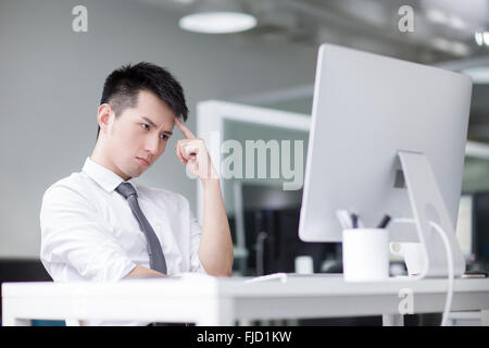 Chinese businessman working in office Stock Photo