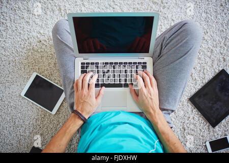 Multitasking man using laptop connecting wi-fi Stock Photo