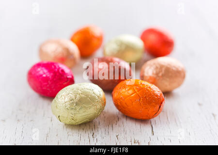 Close up of an assortment of chocolate Easter eggs on a rustic wooden background. Stock Photo