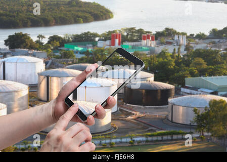 female hand hold and touch screen smart phone,tablet,cellphone big Oil bin Stock Photo