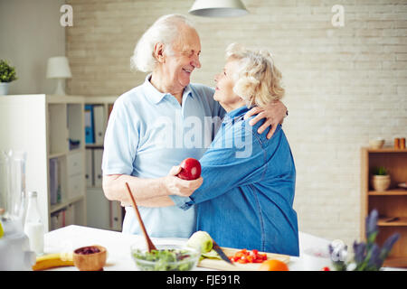 Family of two enjoying each other while cooking Stock Photo