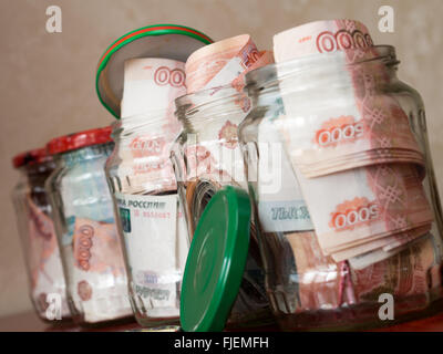 Jars of cash. Glass jars with banknotes Stock Photo