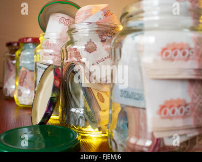 Jars of cash. Glass jars with banknotes Stock Photo