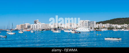 Boats, small yachts and water craft of all size in Ibiza marina harbour in the morning of a warm sunny day. Stock Photo