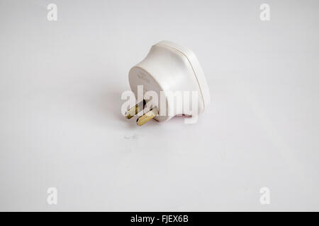 Mains adapter plug with 13 amp 3 pin socket converted to 2 flat pins to be used in the united States of America, Stock Photo