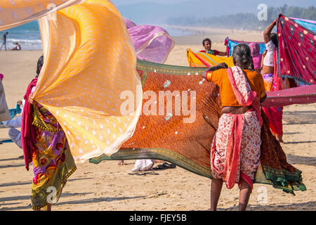 Indian women drying colourful saris on the beach , Gokarana, Karnataka, India Stock Photo