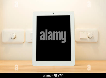 Perfectly detailed modern Tablet placed on a wooden table. Stock Photo