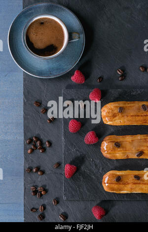 Coffe eclair with raspberries Stock Photo