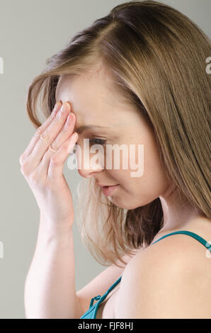 Serious young woman hand touching face Stock Photo