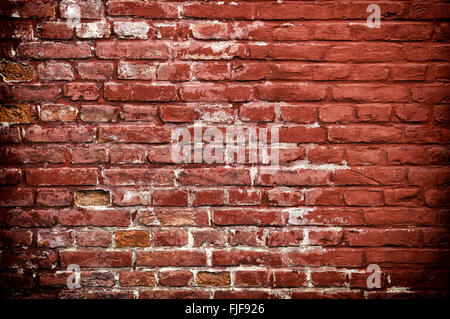 Stone texture - Rustic and worn bricks painted with a red color. Stock Photo