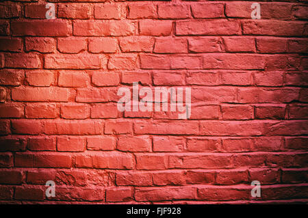 Stone texture - brick wall painted with red color. Stock Photo