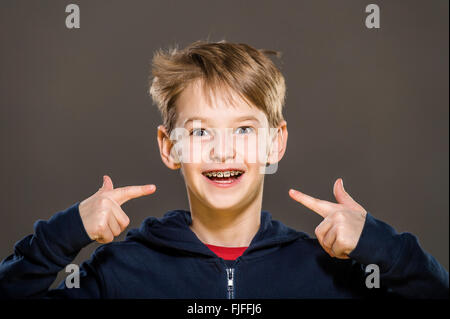 studio portrait of white boy with braces Stock Photo