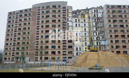 An excavator from a demolition company razes a Plattenbau building from the German Democratic Republic at Juri Gagarin Ring 10 through 16 in Neubrandenburg, Germany, 02 March 2016. The eleven-story apartment house has around 11,000-square-meters of living space. The demolition of the building, built in 1974 with 199 apartments, should be finished at the end of May 2016. The demolition costs are being financed in part by the support of the State of Mecklenburg-Western Pomerania for the stabilization of the housing market through demolition in designated development areas. Photo: Stefan Sauer/d Stock Photo