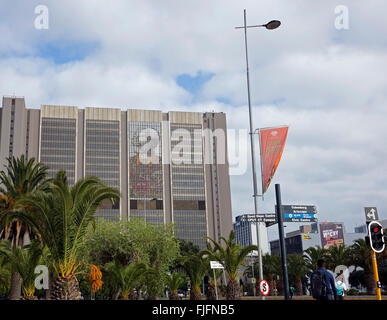 State of the Nation orange banner on the Foreshore in Cape Town with Nelson Mandela portrait on Cape Town Civic Centre building Stock Photo