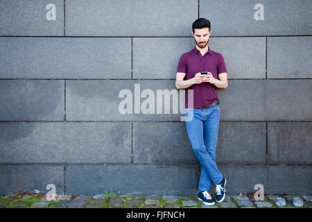Portrait of an attractive young man using smart phone Stock Photo