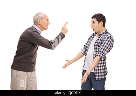 Studio shot of a senior father arguing with his adult son isolated on white background Stock Photo